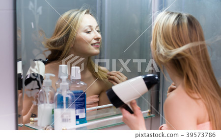 woman hairdryer bathroom 39573786