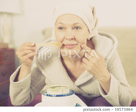 Woman doing body hair removal 39573964