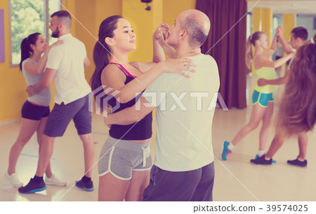 Young men and women are dancing waltz in pairs 39574025