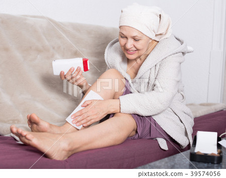 Woman doing body hair removal Woman doing body hair removal 39574056