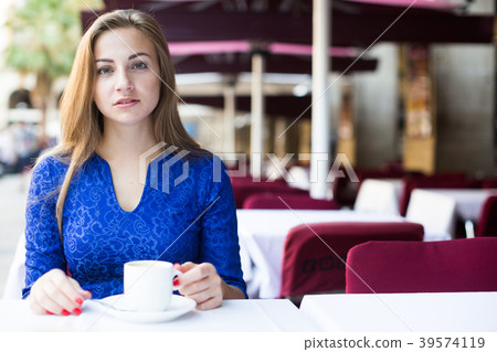 Portrait of cheerful female who is enjoying of breakfast and dream 39574119