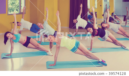 positive people practicing yoga in dance hall positive people practicing yoga in dance hall 39574128