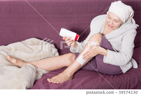 Woman doing body hair removal 39574130