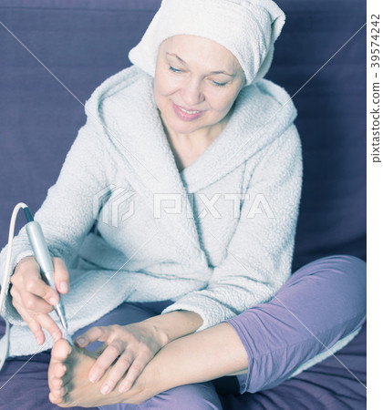 Woman doing pedicure Woman doing pedicure 39574242