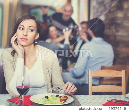 Portrait of upset woman in the restaurant with salad and wine Portrait of upset woman in the restaurant with salad and wine 39574246
