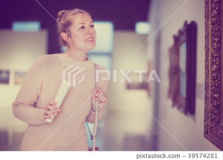 Woman with guide looking at pictures in museum 39574281