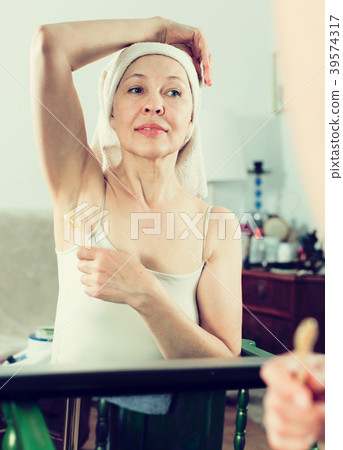 Woman doing body hair removal 39574317