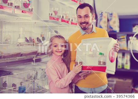 Father and daughter boasting their purchase of canary bird Father and daughter boasting their purchase of canary bird 39574366