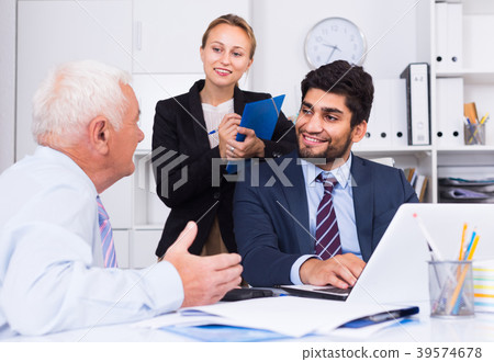 Mature man is talking to colleague Mature man is talking to colleague 39574678