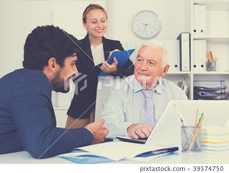Mature man is talking to colleague Mature man is talking to colleague 39574750