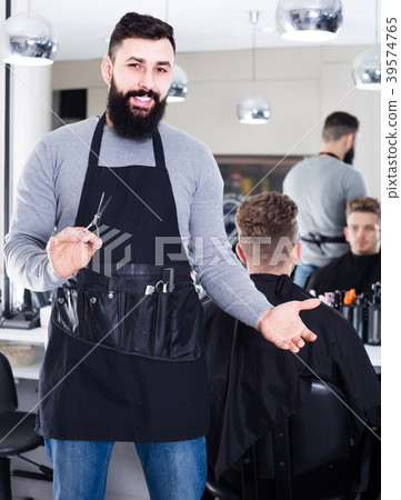 Male Hairdresser Showing His Workplace And Stock Photo