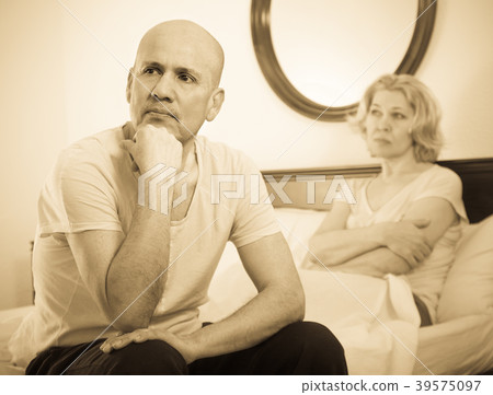 Mature couple sorting out relationships in bed. 39575097