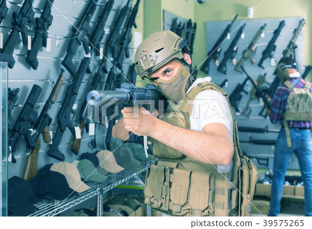 men in army uniform with gun in military market men in army uniform with gun in military market 39575265