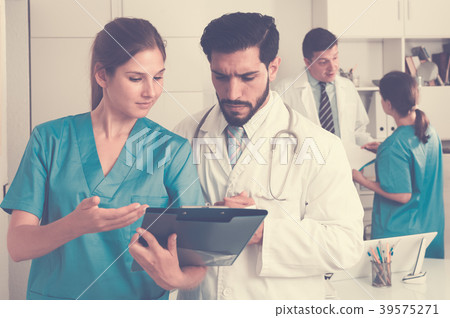 Doctors having discussion in medical office Doctors having discussion in medical office 39575271