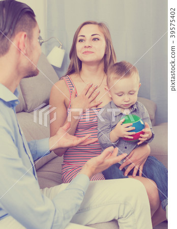 Smiling mother and father with little son talking Smiling mother and father with little son talking 39575402