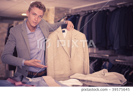 Adult male selling jacket in the store Adult male selling jacket in the store 39575645