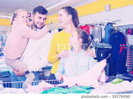 family with two girls choosing new clothes family with two girls choosing new clothes 39576090