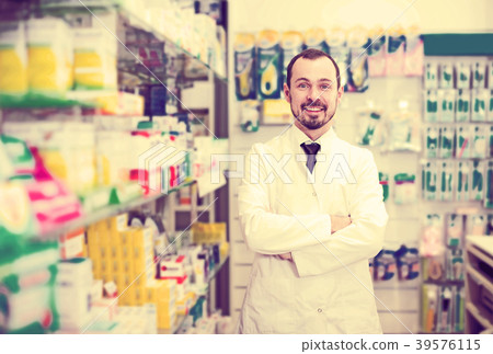 Male pharmacist displaying assortment of drugs Male pharmacist displaying assortment of drugs 39576115