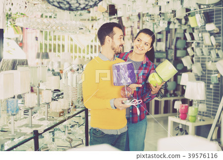 Smiling young man and girl in lighter shop choose night light 39576116
