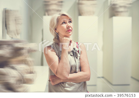 Positive woman in art museum near the antique classical sculpture 39576153
