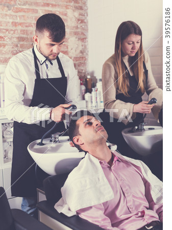 Two men enjoying hairwash by hairdressers 39576186
