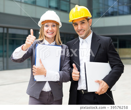 Smiling engineer and woman designer are pleased with realisation their project Smiling engineer and woman designer are pleased with realisation their project 39576258