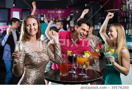 Portrait of smiling females and males having fun in the bar Portrait of smiling females and males having fun in the bar 39576260