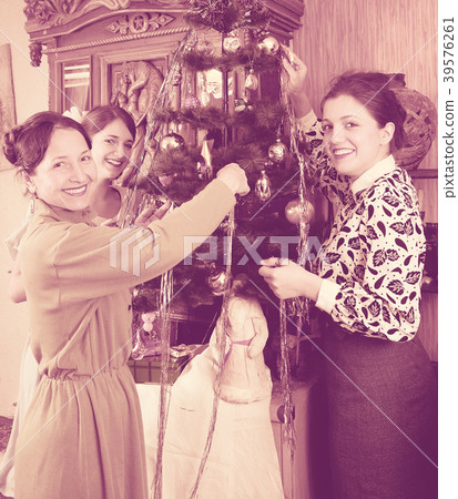 Family decorating Christmas tree at home Family decorating Christmas tree at home 39576261