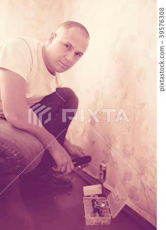 man repairs the socket man repairs the socket 39576308