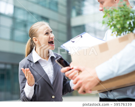 Serious businesswoman is dissatisfied of the results work of young manager Serious businesswoman is dissatisfied of the results work of young manager 39576339