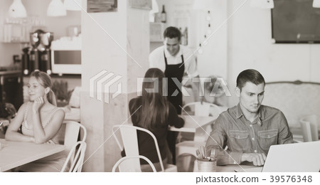Young man spending time with laptop Young man spending time with laptop 39576348
