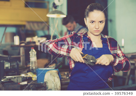 Positive female standing on her workplace Positive female standing on her workplace 39576349