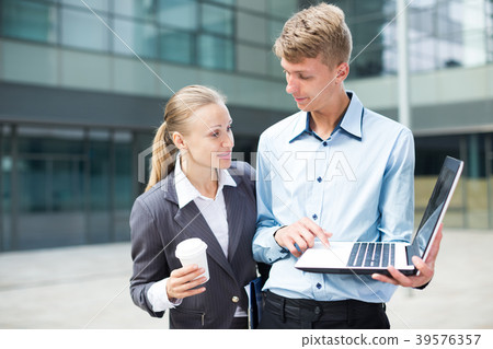 Businessman with his woman partner are looking project on laptop Businessman with his woman partner are looking project on laptop 39576357