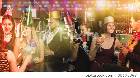 Portrait of young women and men in caps with cocktails Portrait of young women and men in caps with cocktails 39576368