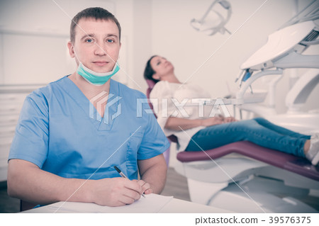 dentist in uniform writing document dentist in uniform writing document 39576375