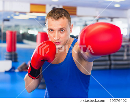 Man boxer is training in gloves in gym. 39576402