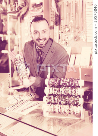 seller showing bracelets in the jewelry shop seller showing bracelets in the jewelry shop 39576840