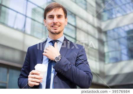 Businessman in suit with cup of coffee 39576984
