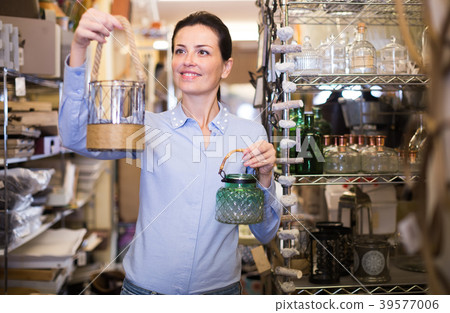 Woman holding whatnot choose for house 39577006