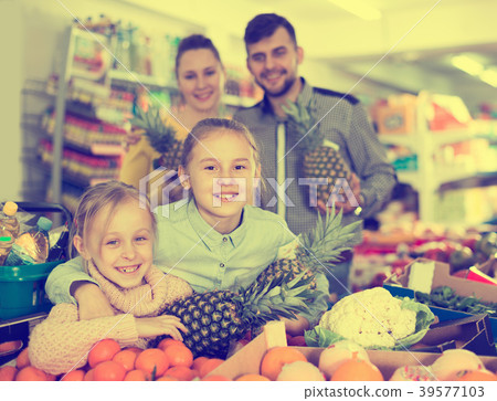 Happy parents with little girls with pineapples Happy parents with little girls with pineapples 39577103