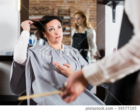 Upset woman in hairdress salon Upset woman in hairdress salon 39577105