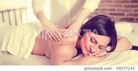 Young masseuse makes relaxing massage shoulder zone to adult woman 39577143