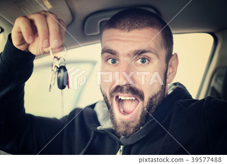 Man shows keys from new car Man shows keys from new car 39577488