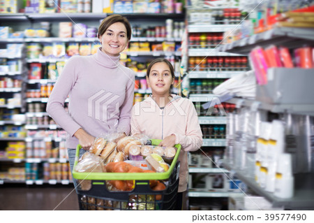 Adult woman and girl with shopping cart Adult woman and girl with shopping cart 39577490