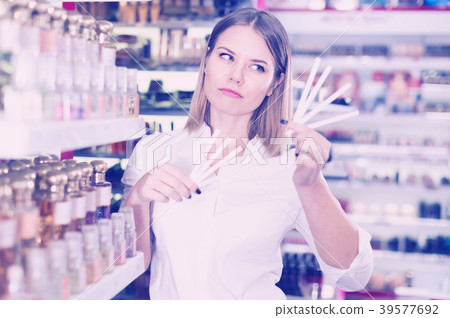 Attractive girl testing fragrance with tester 39577692