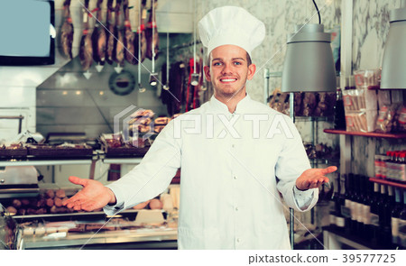 Smiling male seller working at meat market Smiling male seller working at meat market 39577725