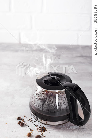 Coffee maker pot filling with coffee beans 39583395