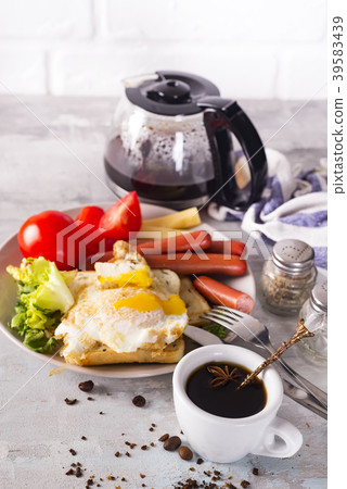 breakfast sandwich with sausage, coffee and tomato 39583439