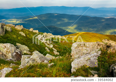 huge rocky formations on the grassy hills 39584002