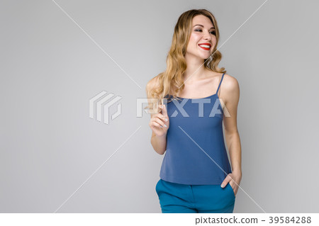 Charming young blonde girl in blue clothes smiling Charming young blonde girl in blue clothes smiling 39584288
